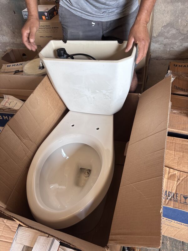 Almond-colored toilet bowl in cardboard box